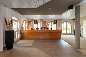 a lobby with a reception desk in a building at Hotel Allegra in Zuoz