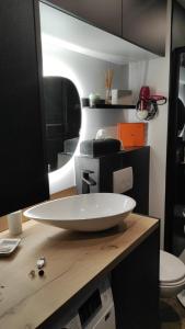 a bathroom with a white sink on a counter at Le Week-End 3 étoiles, plein centre ville in La Clusaz