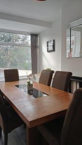 a dining room with a wooden table and chairs at Ribbleton Rendezvous in Preston in Preston