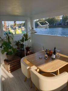 a dining room with a wooden table and chairs at Peniche C'est La Vie in Les Grésillons