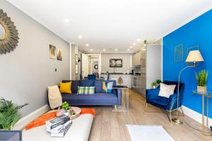a living room with a blue couch and blue chairs at Central London Large 3bed 2bath with massive terrace overlooking grand union canal. (8 occupancy) in London