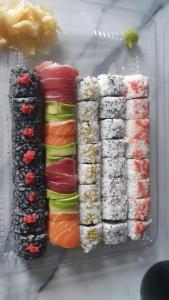 a refrigerator filled with different types of sushi at Charm A Sarajevo in Sarajevo