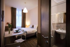 a hotel room with a bed and a sink at East Station Comfort Plus in Budapest