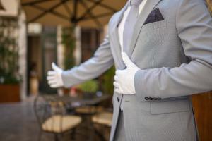 a man wearing a suit and tie at Liassidi Wellness Suites in Venice