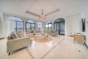 a large living room with a lot of windows at Frond D Villa, Palm Jumeirah - Mint Stay in Dubai