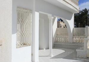 a white porch with a white fence on a house at MB SWEET HOME DJERBA in Houmt Souk