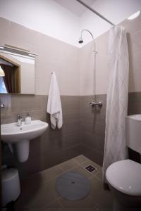 a bathroom with a sink and a toilet and a shower at East Station Comfort Plus in Budapest