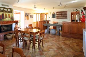 a dining room with a table and a fireplace at Agriturismo Tonutti in Tavagnacco