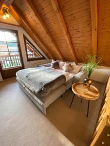 a bedroom with a large bed and a table at VOLLMER home in Titisee-Neustadt