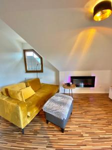 a living room with a couch and a table at VOLLMER home in Titisee-Neustadt