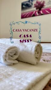 a stack of toilet paper with a sign on it at Casa Sissy in Lamezia Terme