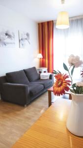 a living room with a black couch and a table at Apartamentos Turísticos Real Valle Ezcaray in Zorraquín