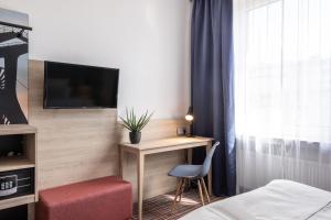 TV a/nebo společenská místnost v ubytování Hotel Ambassador Essen