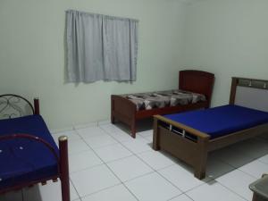 a living room with two beds and a window at CHÁCARA KAUANNY SOCORRO SP in Socorro +54 photos
