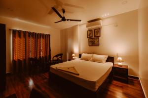 a bedroom with a bed and a ceiling fan at Dibrugarh Tea Residency in Dibrugarh