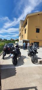 a group of motorcycles parked outside of a building at Villa Malvasio - Piscina & Suite Idromassaggio in Sassari