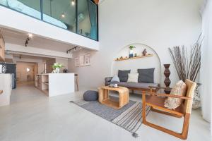 a living room with a couch and a table at The STYLISH Hometel Sukhumvit in Bangkok
