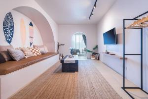 a living room with a couch and surfboards on the wall at The STYLISH Hometel Sukhumvit in Bangkok
