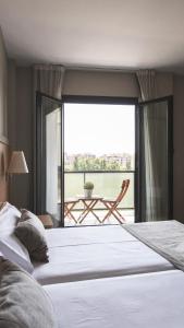 Posteľ alebo postele v izbe v ubytovaní Hotel Real