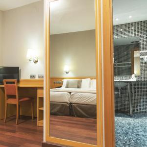 Posteľ alebo postele v izbe v ubytovaní Hotel Real