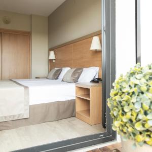 Posteľ alebo postele v izbe v ubytovaní Hotel Real