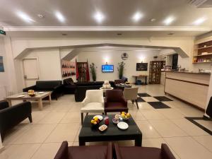 a large living room with couches and a table at Adil Konak Hotel in Istanbul