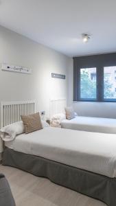 Postel nebo postele na pokoji v ubytování Apartamentos Real Lleida