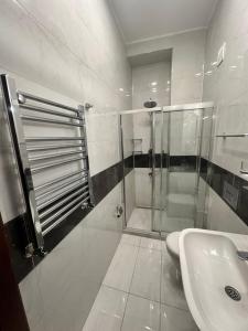 a bathroom with a shower and a sink at Adil Konak Hotel in Istanbul