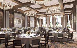 a banquet hall with tables and chairs and chandeliers at Mandarin Oriental, Muscat in Muscat