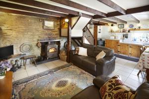 a living room with a couch and a fireplace at Y Cartws near Llangrannog in Llangrannog