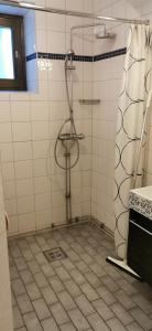 a bathroom with a shower and a tiled floor at Stockholm Classic Budget Hotell in Stockholm