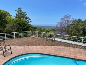 a swimming pool on top of a wooden deck at Winston House in Durban