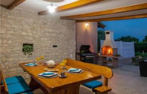 a wooden table and chairs in a patio with a fireplace at Villa Lara in Hreljići