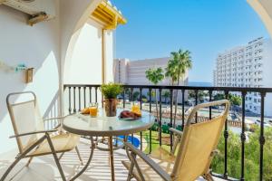 a table and chairs on a balcony with a view at Imperial Puerto 2 4B By IVI Real Estate in Torremolinos