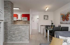 ein Wohnzimmer und eine Küche mit roten Schränken und einem Tisch in der Unterkunft Nerina in Poreč