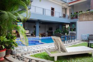 a patio with a chair and a swimming pool at FARAWAY SUITES in Vang Vieng