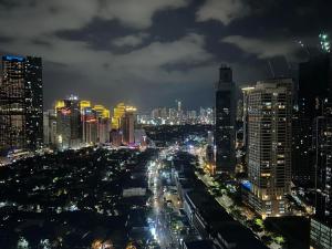 a city lit up at night with cars at Rich Staycation Makati in Manila