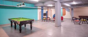 a room with a pool table and some chairs at Yello! ITPL in Bangalore