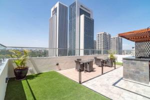 a rooftop patio with tables and chairs on a building at Spacious 1-Bed Apt at Elite (7D) in Nairobi
