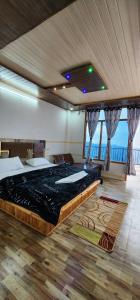 a bedroom with a large bed in a room at HILL MOUNT Cabin Home in Chamba