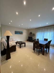 a living room with a table and a bed at Ático Peñíscola in Peñíscola