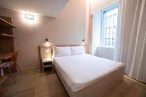 Ein Bett oder Betten in einem Zimmer der Unterkunft Be Mate Torino Centro