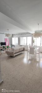 a large room with white furniture and tables and windows at Big and cozy apartment with a big terrace in the center of the old town with AC from 2024 summer season in Marbella