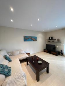 a living room with two couches and a coffee table at Ático Peñíscola in Peñíscola