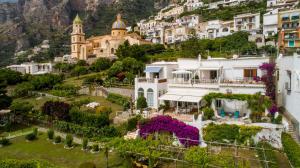 a view of a village with houses and a church at Masa Villas in Praiano