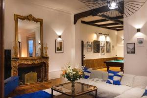 a living room with a couch and a pool table at Private Oasis: Luxe 20-guest Estate, Jacuzzi, 8 Ha in Bazeilles