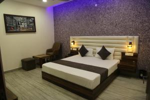 sypialnia z łóżkiem typu king-size i krzesłem w obiekcie Hotel Royal w mieście Rājpura