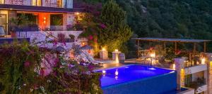 a swimming pool in the backyard of a house at Villa Ilda - Deluxe Holiday Villa - Kalkan,Türkiye in Kalkan