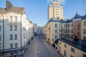 an empty street in a city with tall buildings at Omena Hotel Helsinki City Centre in Helsinki