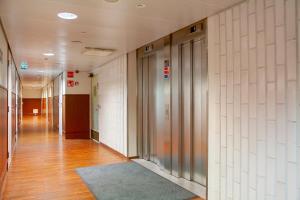 an empty hallway of an office building with a hallway at Omena Hotel Helsinki City Centre in Helsinki +14 photos